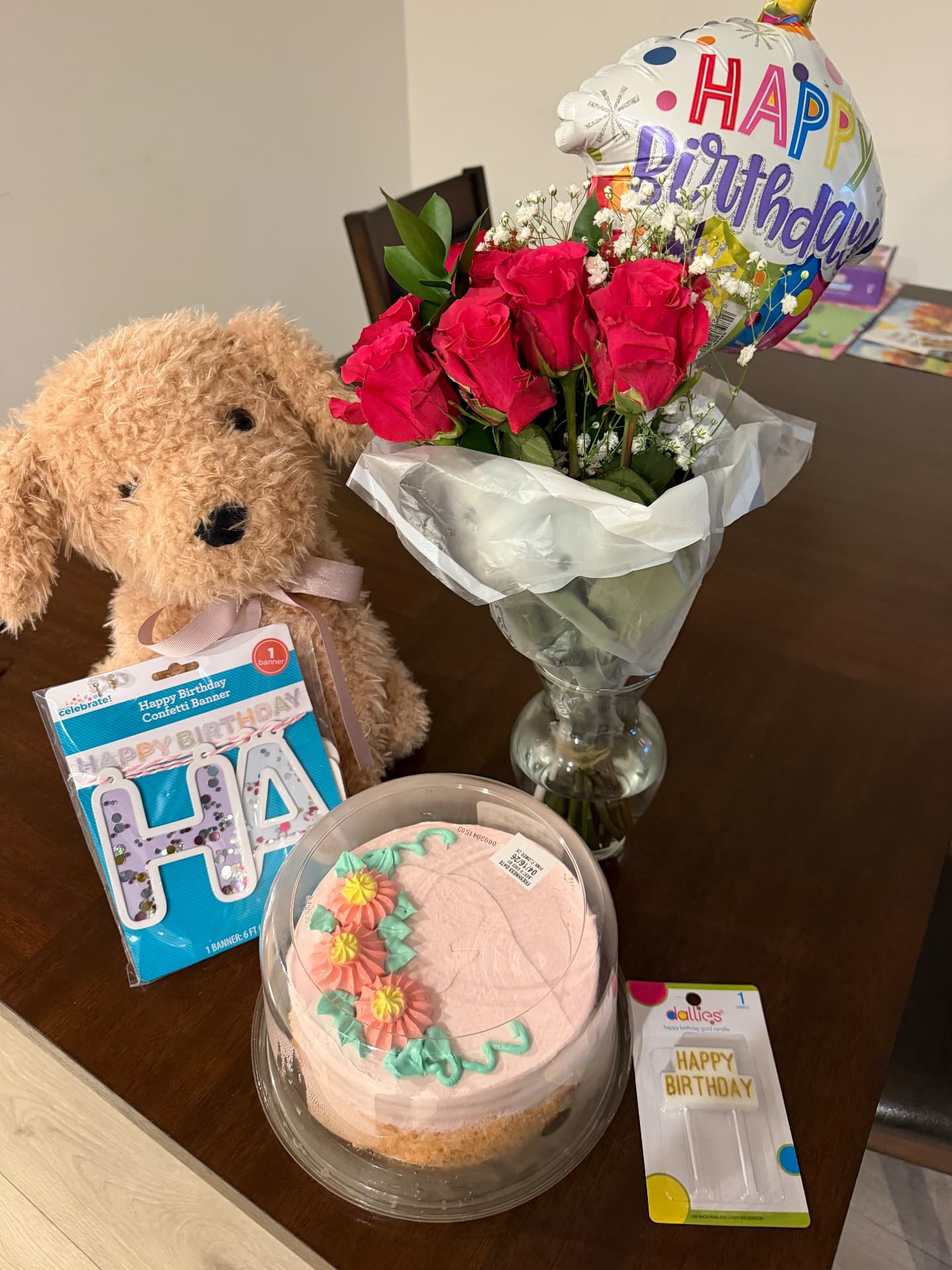 Birthday cake, roses and balloon set out for a resident celebration