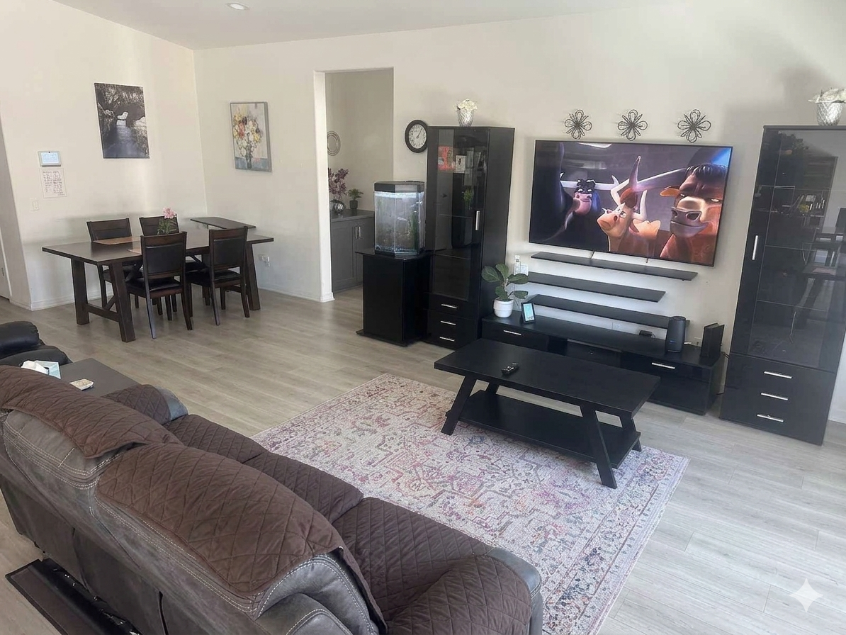 Open living and dining area with recliner sofa and aquarium