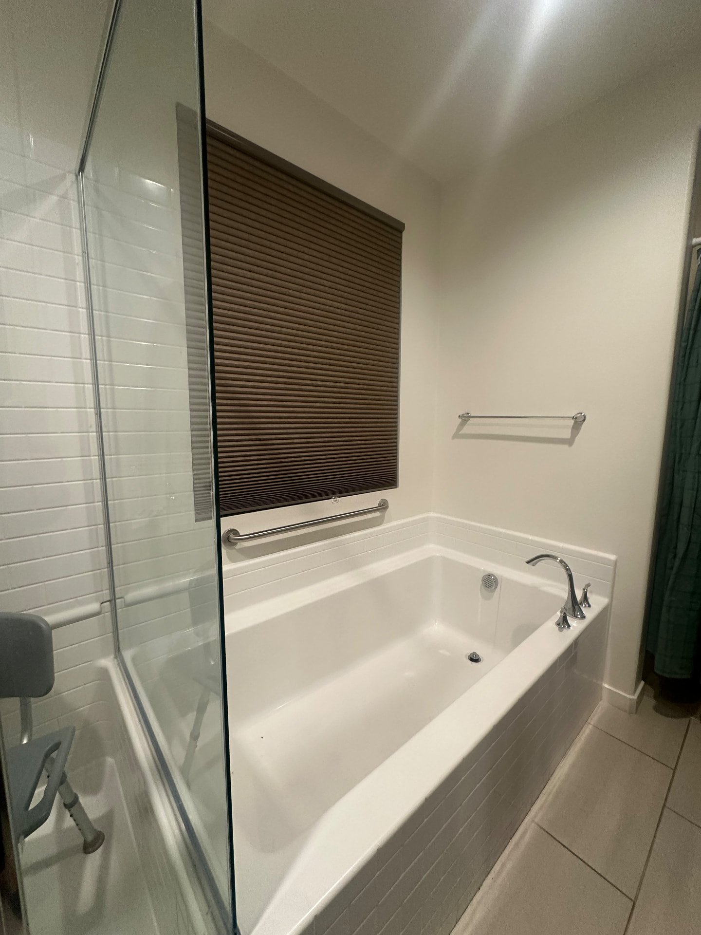 Soaking bathtub with a safety grab bar